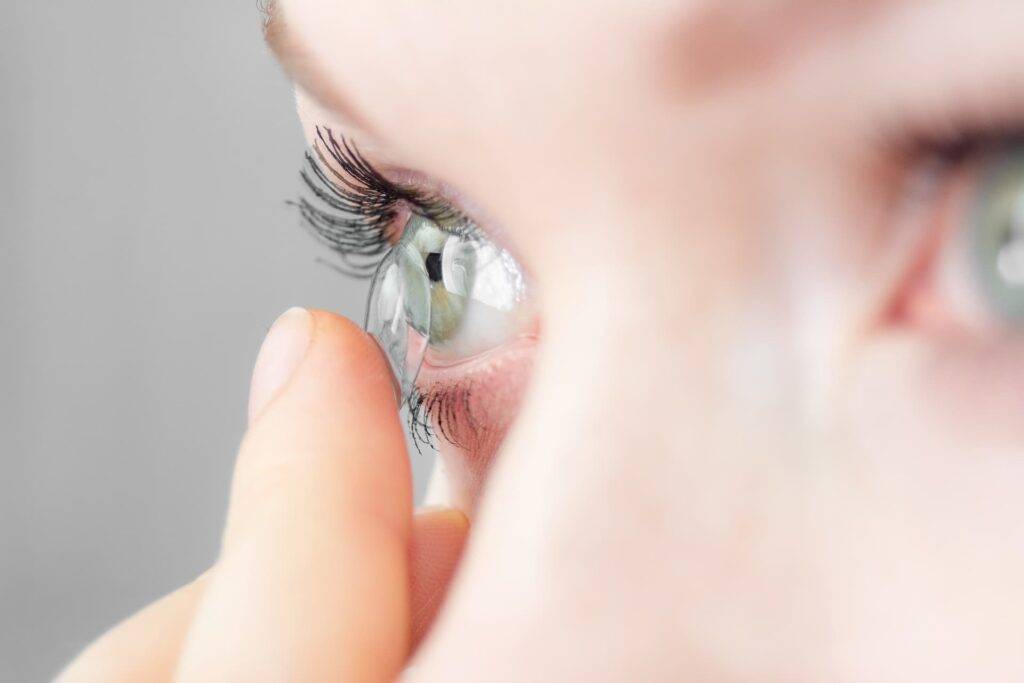 Contact lenses being applied to the eye